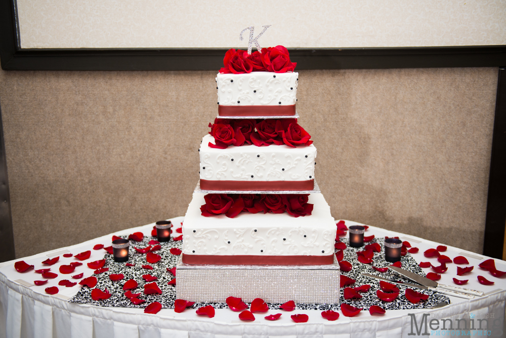 red and white wedding cake with roses